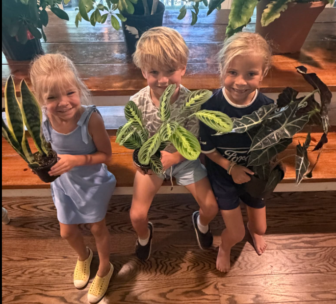 Chase’s three children proudly holding their plants